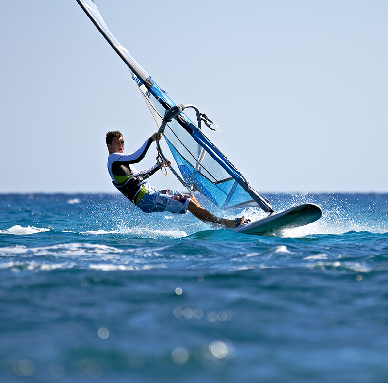 Side view of young windsurfer